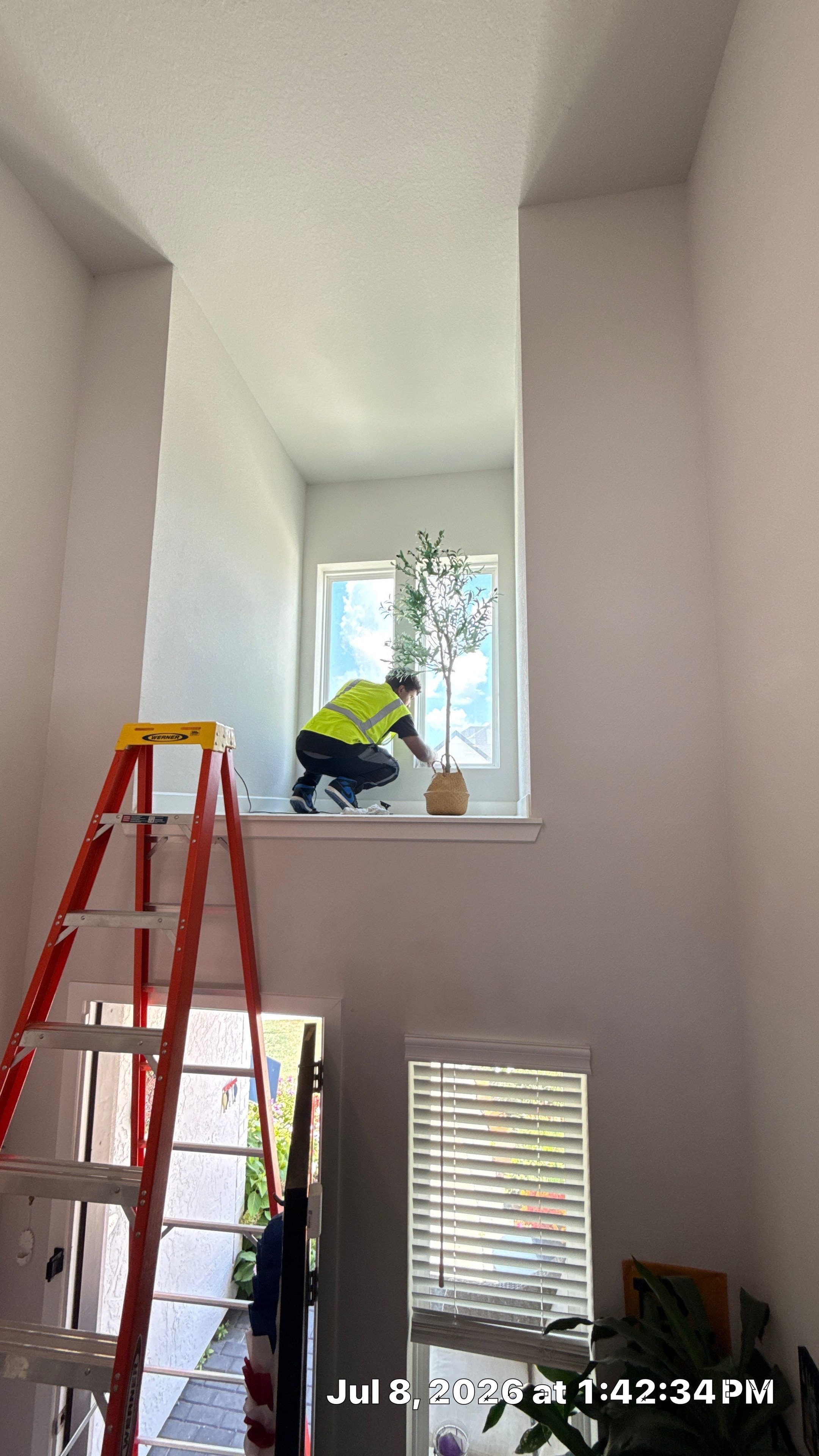 Butler CCS technician on ladder during air quality service